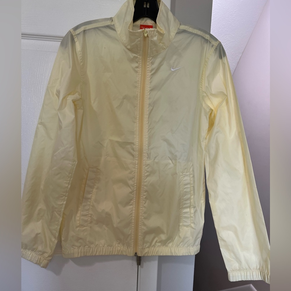 Nike women’s wind breaker, with zipper and pockets  yellow color